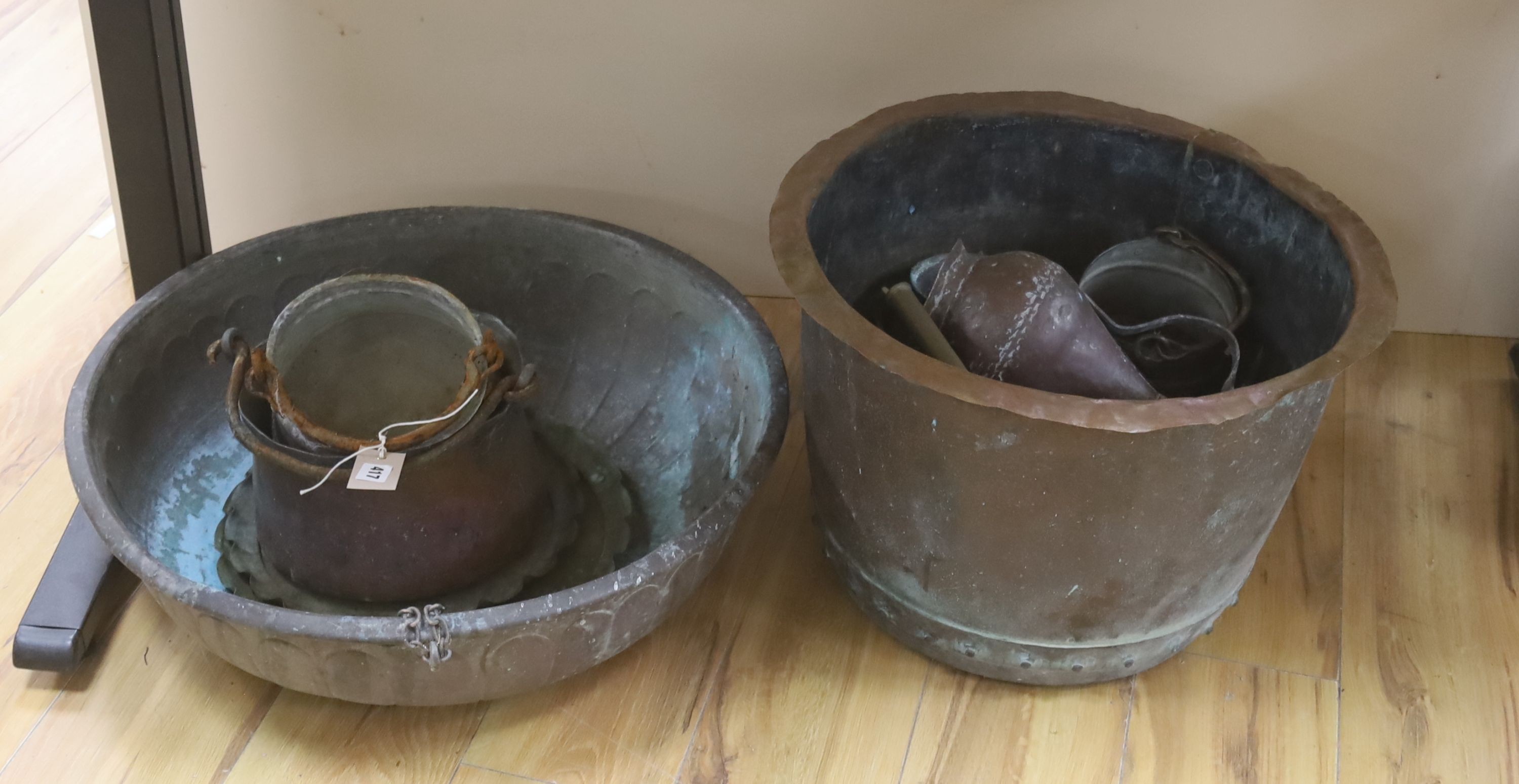 Two large copper bowls and related items, largest 54 cms diameter.